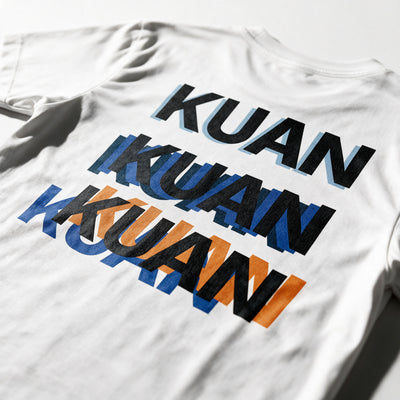 Close-up of the Kuan tee back print in white, the word stacked three times out of register in black, blue and orange