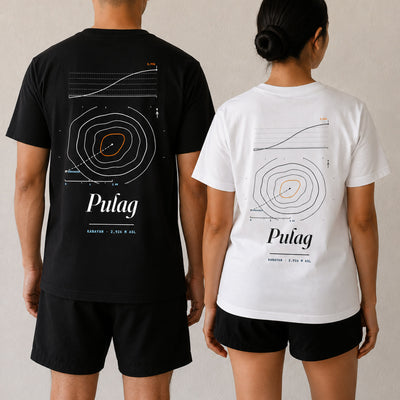 Two people seen from behind in the Pulag tee, Midnight Black and white, the same summit map across both backs
