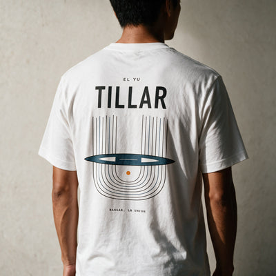 Man in the white Tillar tee, back view, TILLAR over the Ilocano handloom print